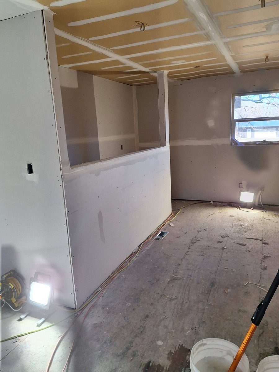 Room with ceiling drywall seams and wall finishing in progress