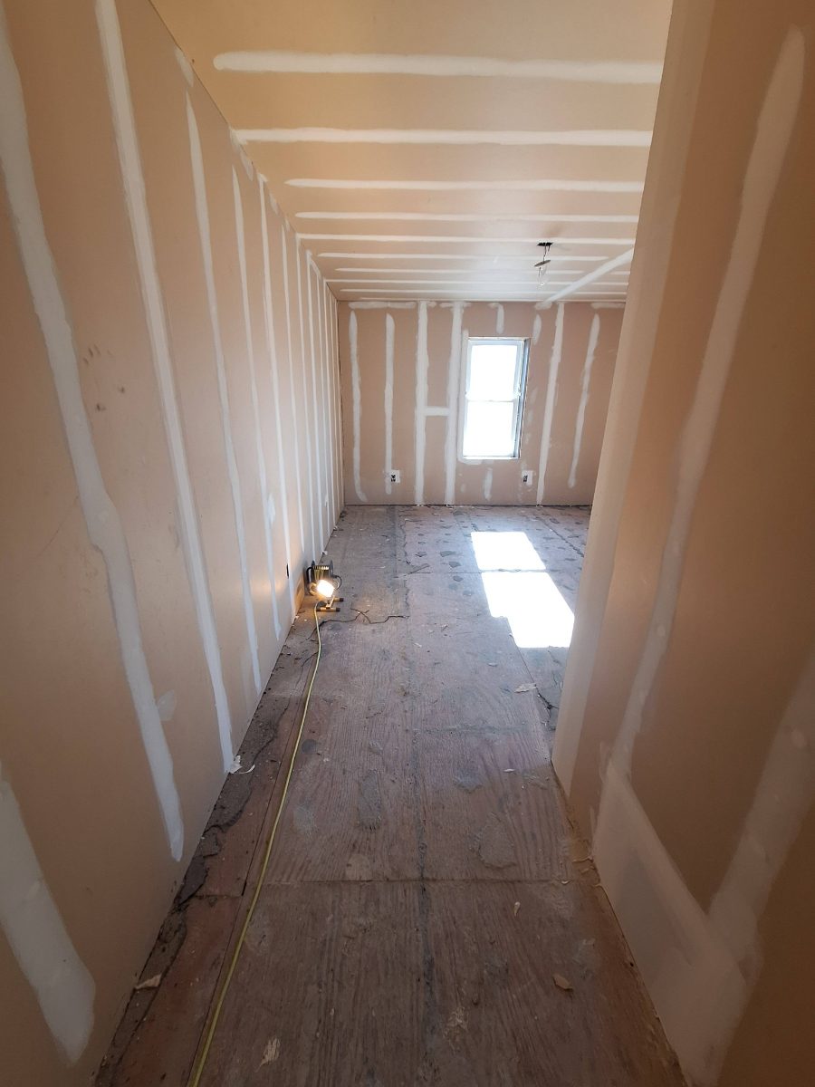 Drywall installation and finishing around an interior room opening